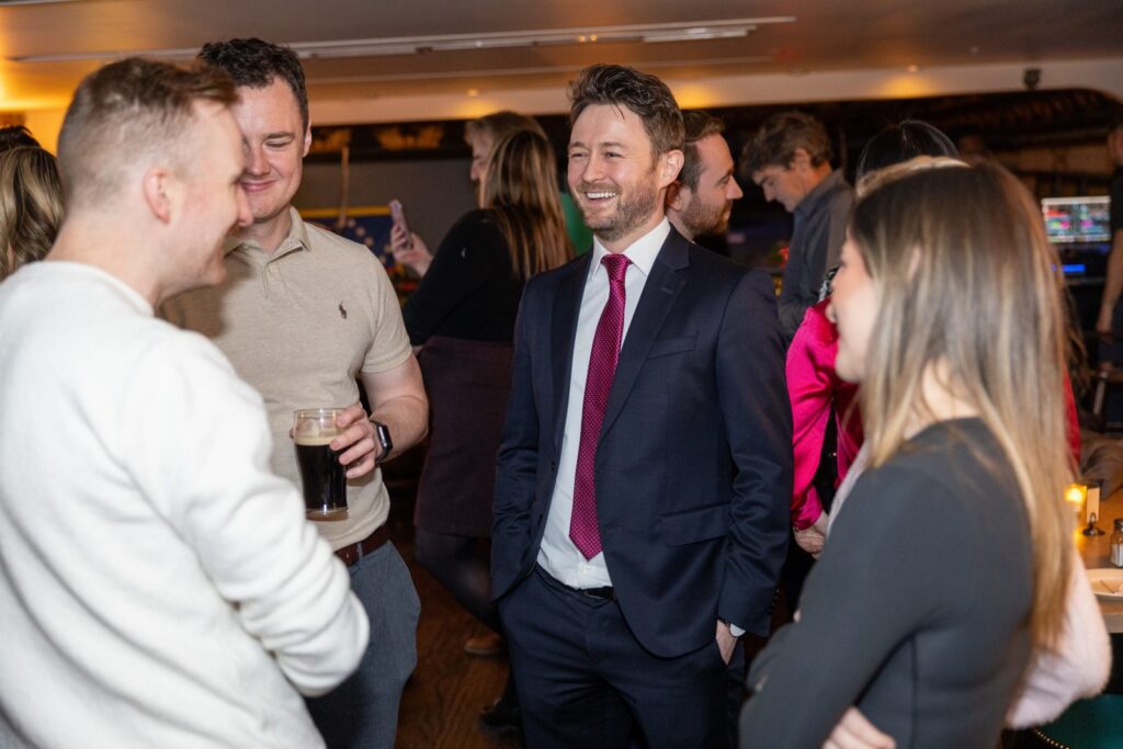 Darren T. Moore talking with guests at IABANY's Leap Day post-bar celebration in New York